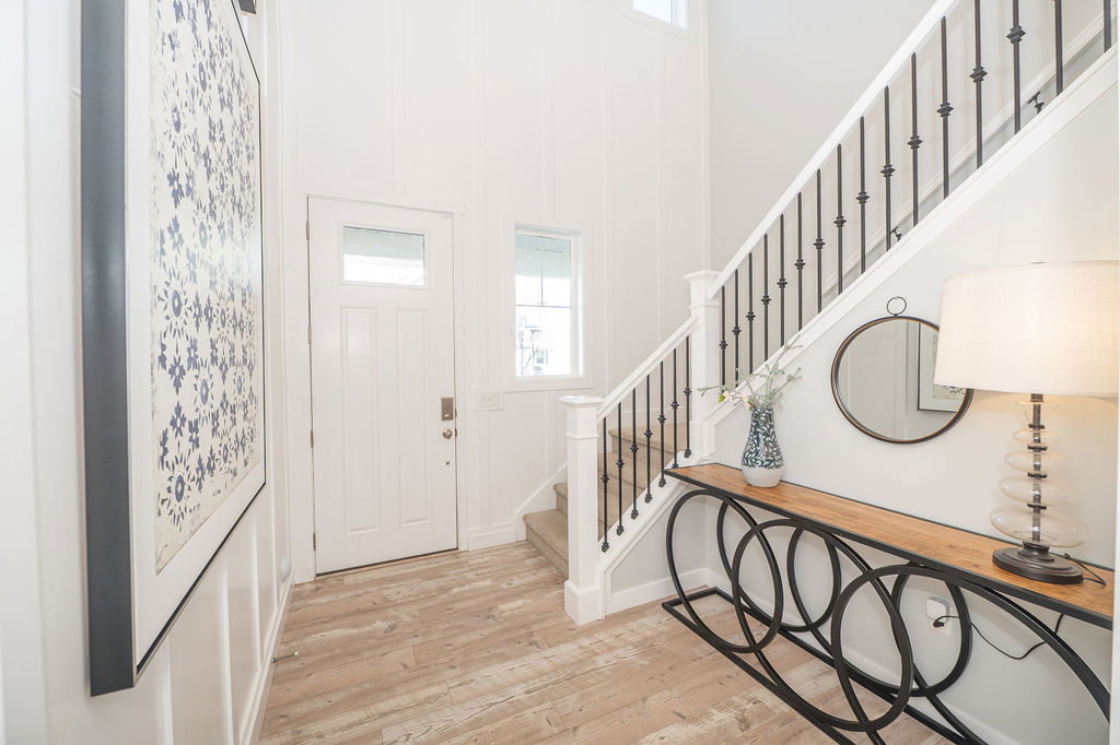 Foyer entrance featuring light wood-style flooring and a high ceiling