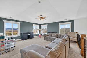 2nd floor Living area featuring carpet floors, ceiling fan, and vaulted ceiling