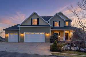 Craftsman house featuring concrete driveway, board and batten siding, covered porch, a shingled roof, and a garage