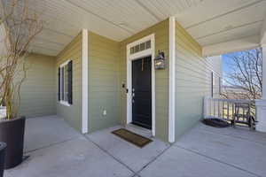 Doorway to property featuring a porch