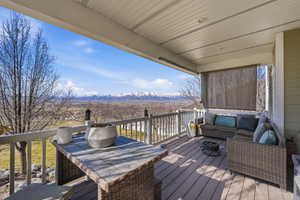Wooden terrace with outdoor lounge area and a mountain view
