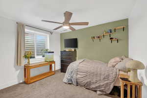 basement Bedroom featuring carpet and ceiling fan