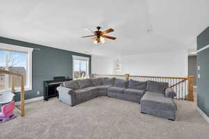 2nd floor Living area with a ceiling fan, carpet floors, healthy amount of natural light, and a tray ceiling
