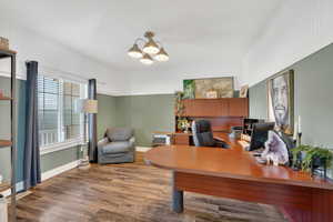 Office area featuring wood finished floors and suspended lighting