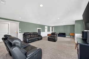 basement Living area featuring light carpet and recessed lighting