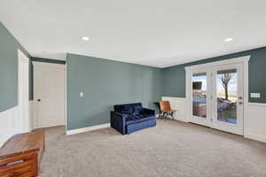 basement Living area featuring wainscoting, with walkout entry