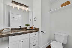 Half bath featuring toilet and vanity