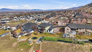 Aerial overview of property's location with nearby suburban area and a mountain backdrop