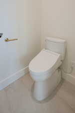 Bathroom featuring baseboards and toilet