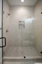 Bathroom with a shower stall and recessed lighting