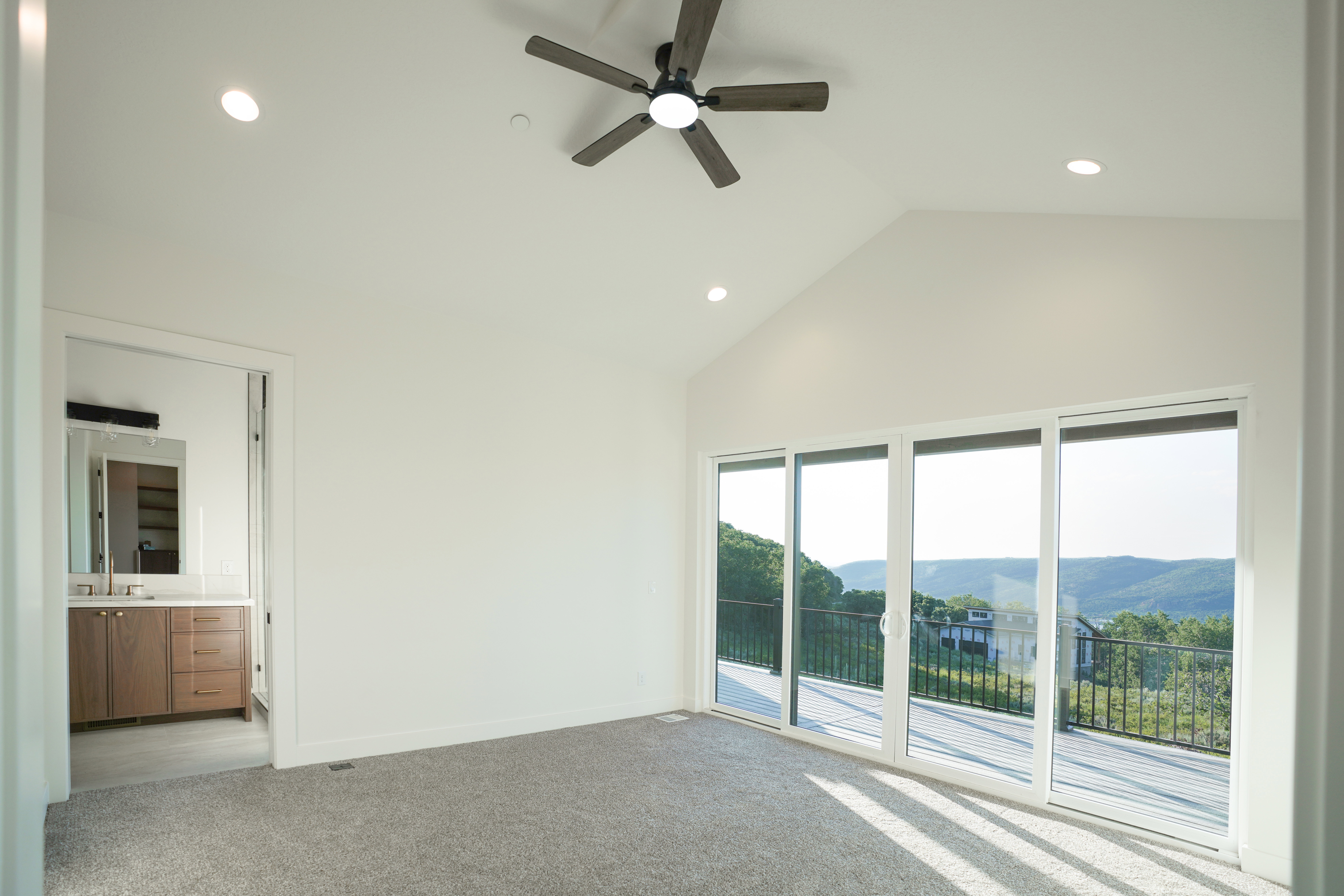 Spare room with light carpet, a high ceiling, recessed lighting, a ceiling fan, and a mountain view