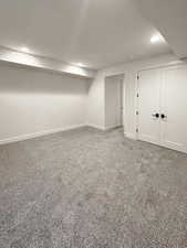 Finished below grade area with carpet flooring and recessed lighting
