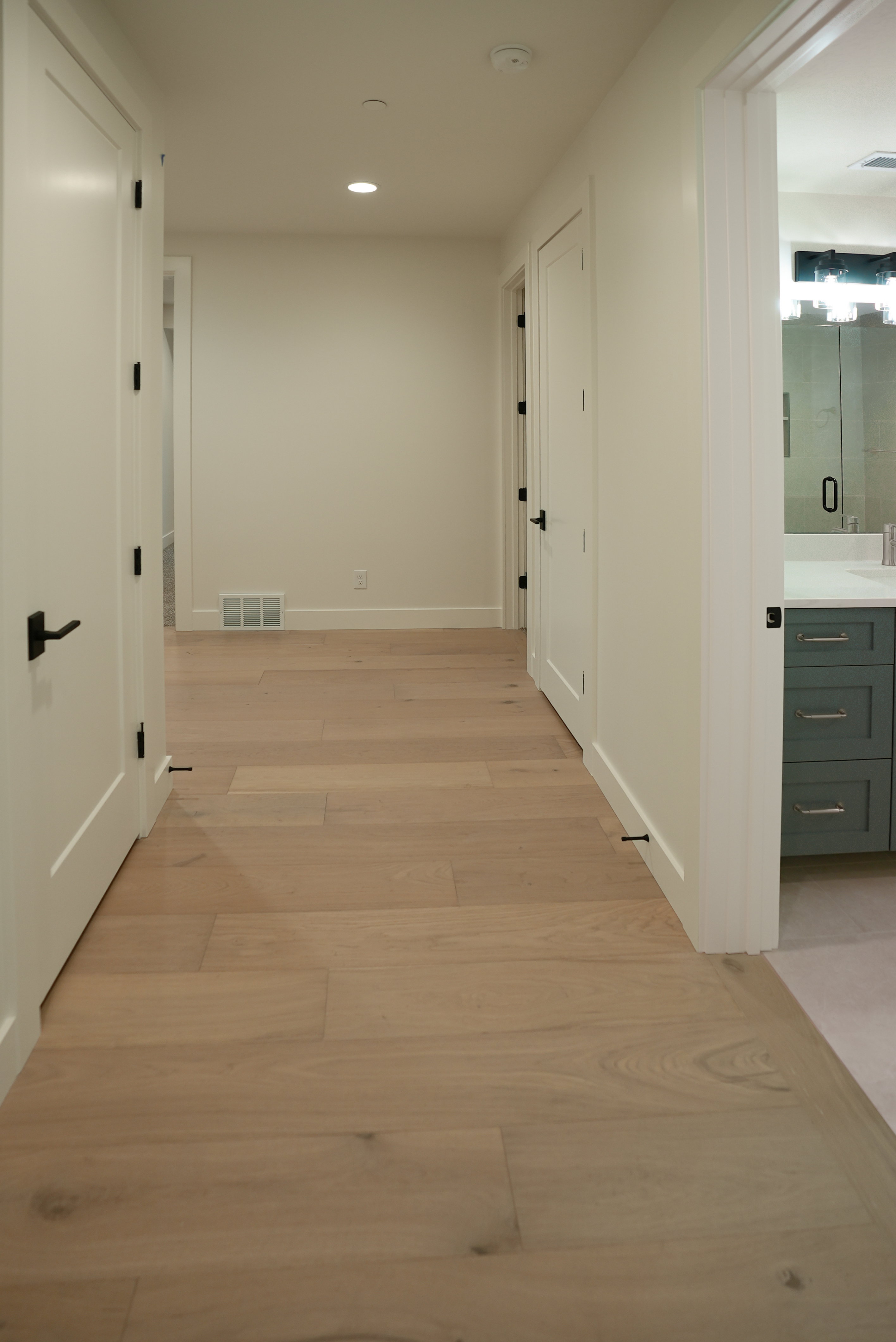 Hallway featuring light wood-type flooring and recessed lighting