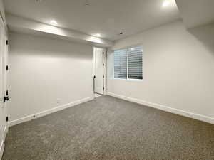 Finished below grade area featuring dark carpet and recessed lighting