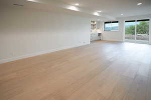 Unfurnished living room with light wood-style floors and recessed lighting