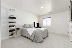 Bedroom featuring light colored carpet