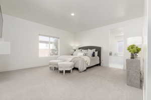 Bedroom featuring light colored carpet and connected bathroom