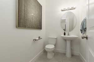 Bathroom featuring toilet and light tile patterned floors
