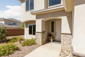View of exterior entry featuring stucco siding