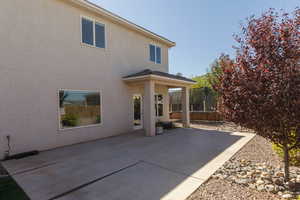 Back of house with a patio and stucco siding