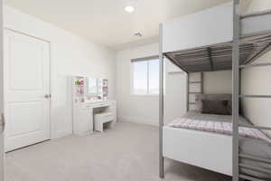 Bedroom featuring light carpet and recessed lighting