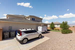 View of side of home featuring stucco siding and a tile roof