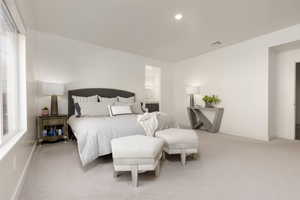 Carpeted bedroom with baseboards and ensuite bath