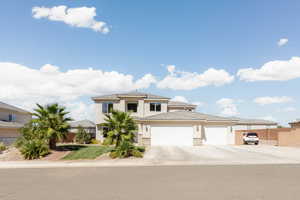View of front of home with a garage, stucco siding, and concrete driveway