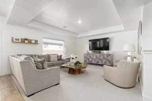 Living room with a raised ceiling and baseboards