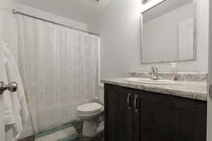 Bathroom featuring vanity and shower / tub combo with curtain