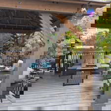 Deck with an outdoor living space with a fire pit