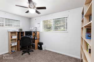 Home office featuring carpet flooring and a ceiling fan