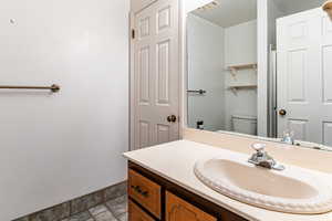 Bathroom featuring stone finish flooring and vanity