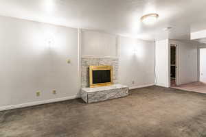 Unfurnished living room featuring a fireplace and carpet flooring