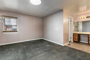 Unfurnished bedroom with carpet flooring and baseboards