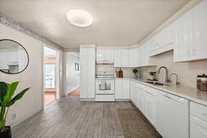 Kitchen with white appliances and white cabinetry