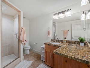 Full bathroom featuring vanity and a shower stall