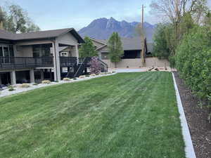Summer backyard featuring a deck with mountain view