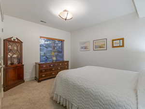 Bedroom with light colored carpet