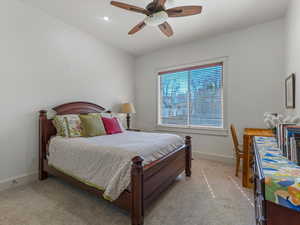 Bedroom with ceiling fan, light carpet, and recessed lighting
