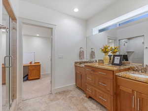 Bathroom featuring a stall shower, vanity, and recessed lighting