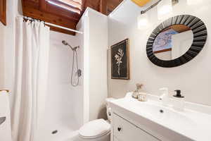 Full bathroom with vanity and a stall shower