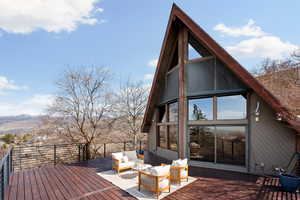 Wooden terrace with outdoor seating and a sunroom