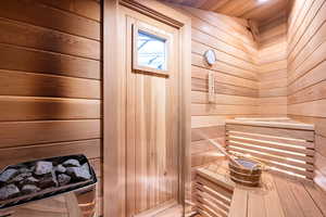 Sauna featuring wood walls and wooden ceiling