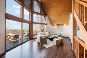 Living area featuring hardwood / wood-style floors and a vaulted wooden ceiling