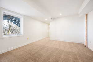 Carpeted spare room featuring baseboards and recessed lighting