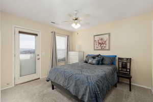 Bedroom with access to exterior, light carpet, and ceiling fan