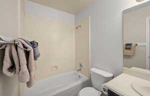 Bathroom with vanity and shower / washtub combination