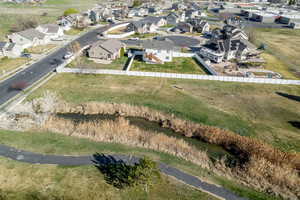 Aerial view of property and surrounding area featuring green space, slough and walking trail