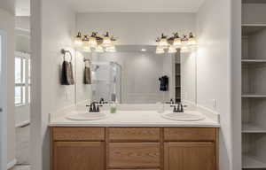 Master Bathroom with double vanity and a stall shower